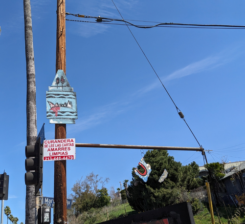 Fanged crayon art hanging from a utility pole