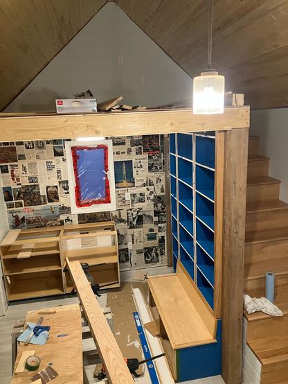 Interior of the cabins showing loft, stairs, a built in bench and shelves and cabinets.