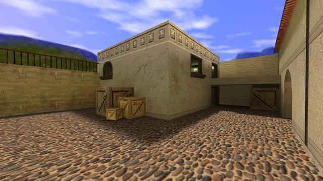 In this picture you can see the house that you saw in the previous picture at the end of the underpass. This can be seen on the right. To the left of the house are three wooden boxes of different sizes (small, medium, large). Through this you can access the first floor via the second window on the first floor. On the right you can see the window on the first floor, which you had already seen in the underpass. Next to it is a passage to a balcony. Among these is the entrance to the house, which has no door. In front of the entrance and under the balcony is also a large box. This is on the map cs_italy in the game Counter-Strike 1.6.