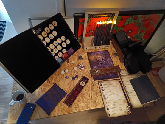 Game materials for Blood on the Clocktower. You can see the Grimoire, player sheets and the candles we used for dead player votes.