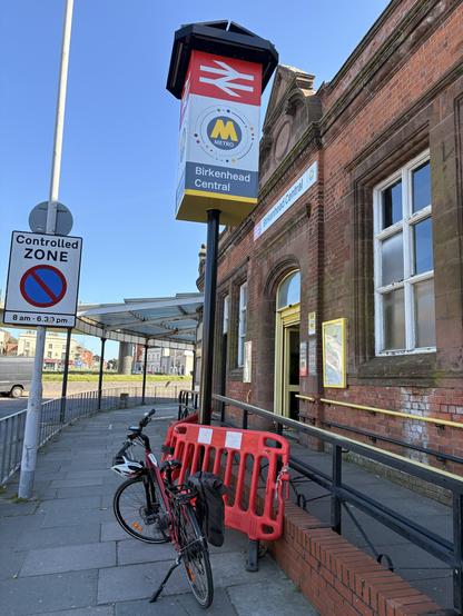 My bike in front of Birkenhead Central railway station.