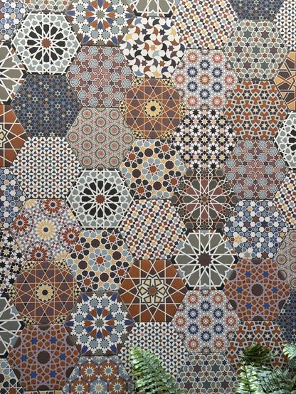 Ceramic tiles in the shape of hexagons and with colorful geometric patterns, on the wall of a courtyard in a coffee shop in San Juan, PR.