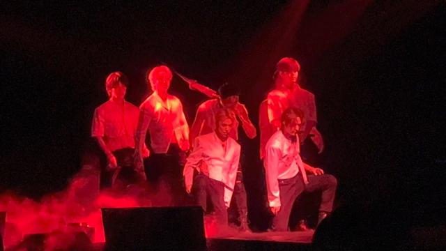 Stray Kids members performing the OT8 version of Red Lights on stage