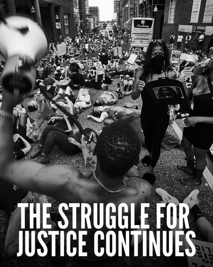 Text: The Struggle for Justice Continues
Photo: A civil disobedient action with people laying down in the street, as if they have been killed