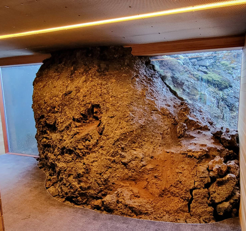 A hallway in the Silica Hotel where it intentionally built around this bit of cooled lava making it part of the interior decor.