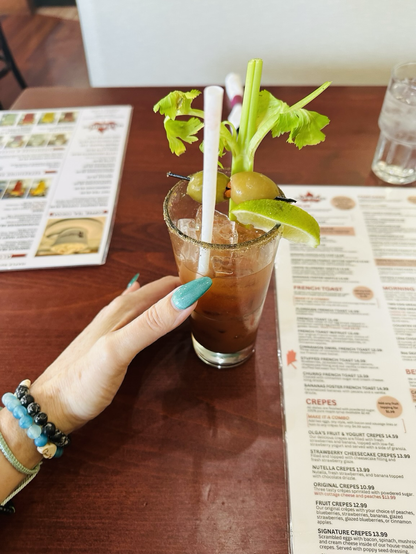 Photo of a Bloody Mary with leafy celery and green olives garnish