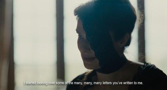 A woman with a lace bandage over one eye. She’s saying, “I started looking over some of the many, many, many letters you’ve written to me.”