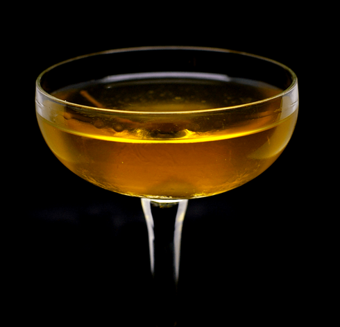 The cocktail itself in a chilled coupe and garnish with a caperberry