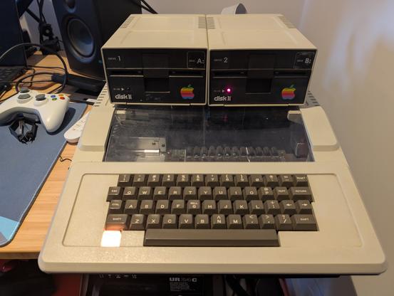 Both Disk II drives sitting on top of the Apple II case in functional order.