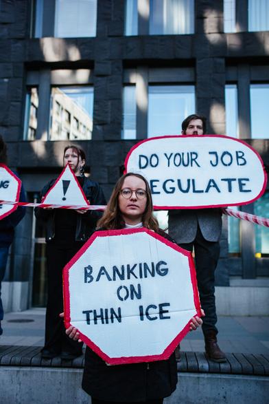 3 protesters with their placards.