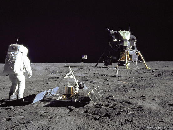 NASA Apollo 11 photo of Buzz Aldrin standing next to the first lunar seismometer, which he and Armstrong had installed

NASA APOD image caption https://apod.nasa.gov/apod/ap250406.html

 Why are there so many moonquakes? Analyses of seismometers left on the moon during the Apollo moon landings reveal a surprising number of moonquakes occurring within 100 kilometers of the surface. In fact, 62 moonquakes were detected in data recorded between 1972 and 1977. Many of these moonquakes are not only strong enough to move furniture in a lunar apartment, but the stiff rock of the moon continues to vibrate for many minutes, significantly longer than the softer rock earthquakes on Earth. The cause of the moonquakes remains unknown, but a leading hypothesis include tidal gravity from -- and relative heating by -- our Earth. Regardless of the source, future moon dwellings need to be built to withstand the frequent shakings. Pictured here, Apollo 11 astronaut Buzz Aldrin stands beside a recently deployed lunar seismometer, looking back toward the lunar landing module.