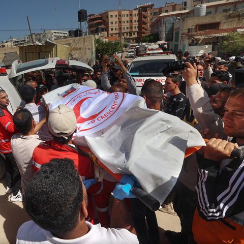 Members of the Palestine Red Crescent and other emergency services last Monday carrying the bodies of rescue workers killed a week earlier by Israeli forces in Gaza.