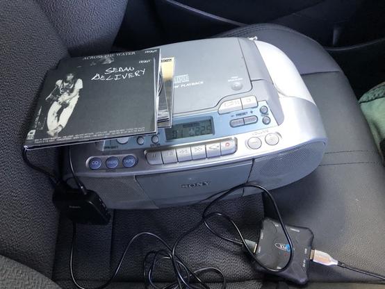 A sony boombox with NY CDs and a mess of cable.