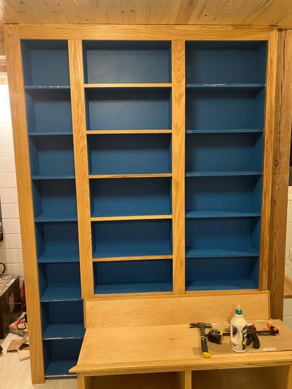Set of built in shelves. Dark blue interior with hardwood face frames. Still not completed.  Some shelf faces still need to be installed.