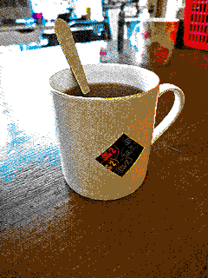 A heavily pixelated and dithered picture of a white mug with the OS/2 logo on it