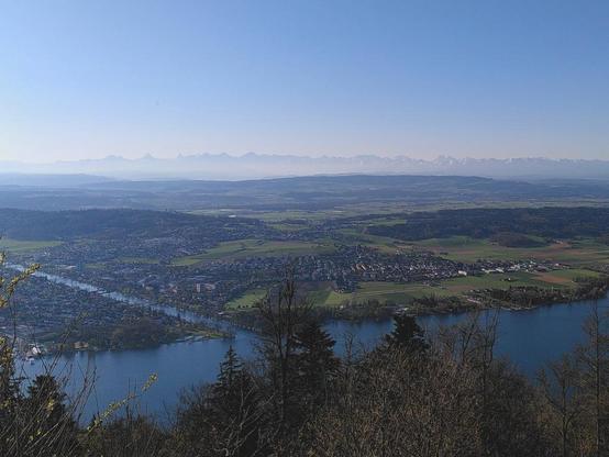 A photograph of the city and lake of Biel with the mountains visible in the haze