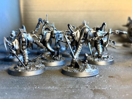 A kill team of extremely sharp-looking mechanical horrors draped in tattered rags