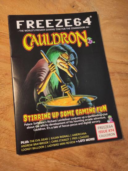 The cover of Freeze64 issue 74. It shows the caricature of a witch stirring in a cauldron. The main headline is "Cauldron" with "Stirring up some gaming fun" as the sub-headline.