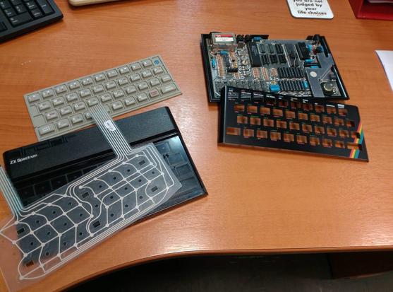 Photo of my deconstructed ZX Spectrum. Showing the open case, brand new "issue 1" keymat in light grey, new membrane PCB and new faceplate.