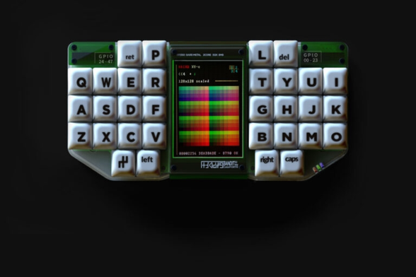 Ortholinear split keyboard computer with tiny screen showing a color palette inbetween the two halves.

The keyboard layout looks as follows:

  Ret P   L Del
Q W E R   T Y U I
A S D F   G H J K
Z X C V   B N M O
Gr Left   Right Caps

with "Gr" being a shift stick schemata like symbol probably switching to some graphics mode. All keys are 1u wide and aligned at the center screen except the bottom row which seems to have been moved a tiny bit outwards.