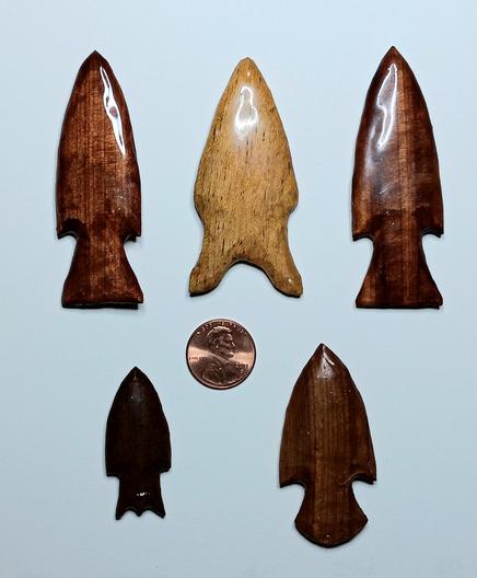 5 carved projectile points made of red cedar, black walnut & pine.