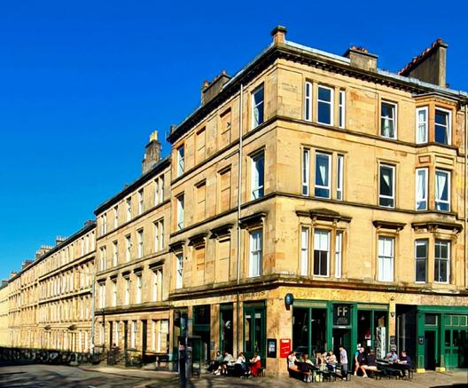 Classical style blonde sandstone Glasgow tenements in the sunshine.