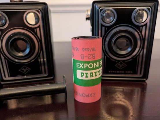 Color Photo of two Agfa Box cameras and a roll of Perutz B2 film.