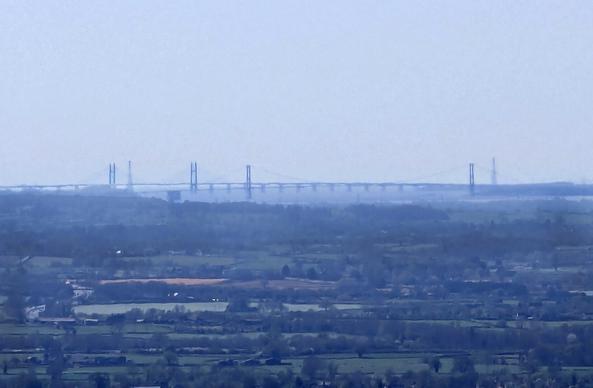 An image of various rural areas in Gloucestershire (with Stonehouse out of frame due to it being at 20x zoom). A bridge can be seen, crossing the River Severn into Wales.