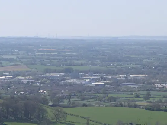 An image of Stonehouse in Gloucestershire. Factories and various industrial buildings can be seen, alongside countryside and a Severn bridge further on.