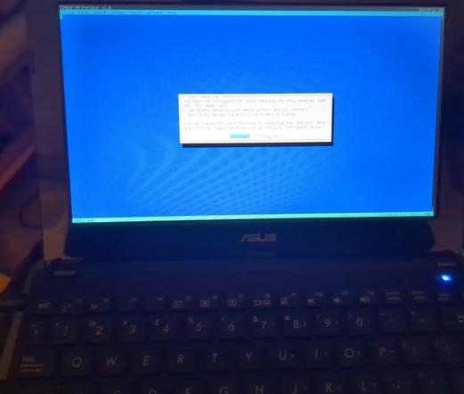 ASUS netbook showing the tilde text editor in Tinker WriterDeck OS on first boot.