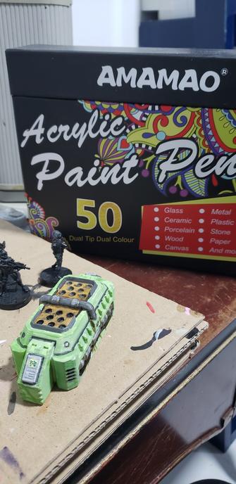 Painted 3d printed industrial terrain in an industrial green, with various metallic parts.