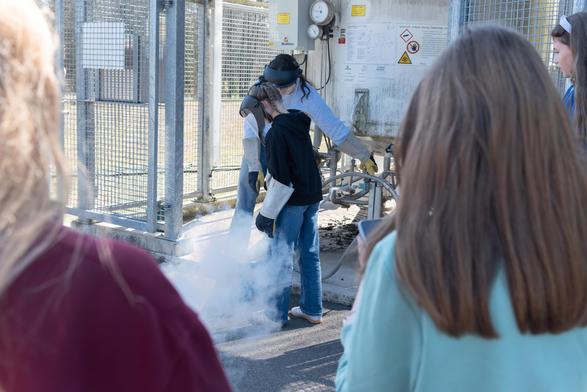 A girl helps to fill liquid nitrogen.