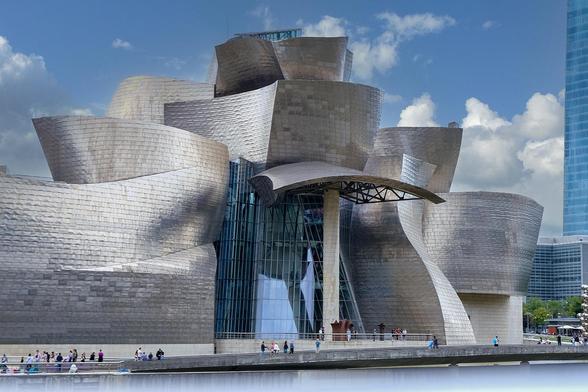 The Guggenheim Museum by Frank Gehry on the banks of the River Nervion, Bilbao, Basque Country, Spain

Designed by Canadian American architect Frank Gehry, the Guggenheim Museum Bilbao building represents a magnificent example of the most groundbreaking 20th-century architecture. With 24,000 m2, of which 9.000 are dedicated to exhibition space, the Museum represents an architectural landmark of audacious configuration and innovating design, providing a seductive backdrop for the art exhibited in it.

Altogether, Gehry’s design creates a spectacular sculpture-like structure, perfectly integrated within Bilbao’s urban pattern and its surrounding area.