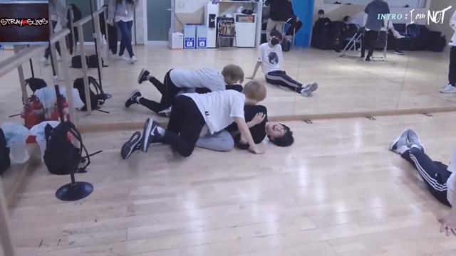 Felix has tackled I.N to the floor in a dance practice room