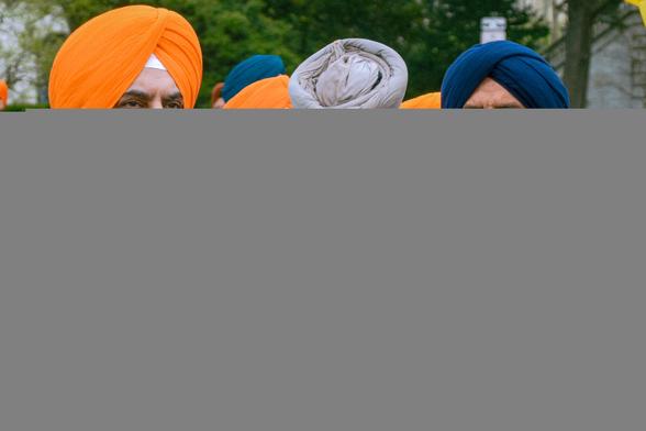 Two Sikh gentlemen in foreground, with a few others in the background.