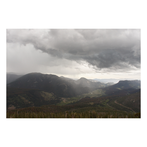 view of vast valley with storm clouds merging sky and earth