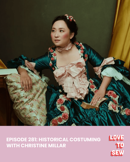 Christine wears a peacock blue 18th century gown with pink bows and trimmed with roses.