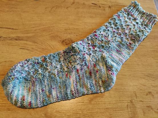 Hand knitted sock in speckled blue cotton and merino yarn