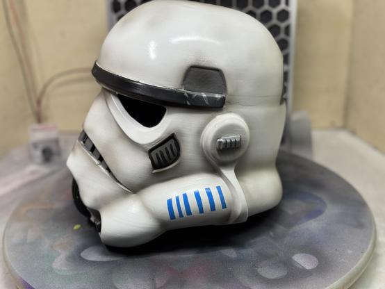 A 3d printed stormtrooper helmet from Star Wars looking dirty and used. The image shows it from its left side.