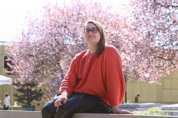 Me again in the same outfit. This time im sitting on a ledge with cherry blossoms in the background