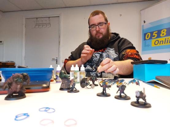 Goblins and trolls being painted by a young fella with a giant beard