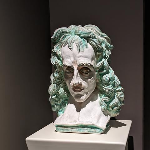 Bust of a demented looking individual with green hair.