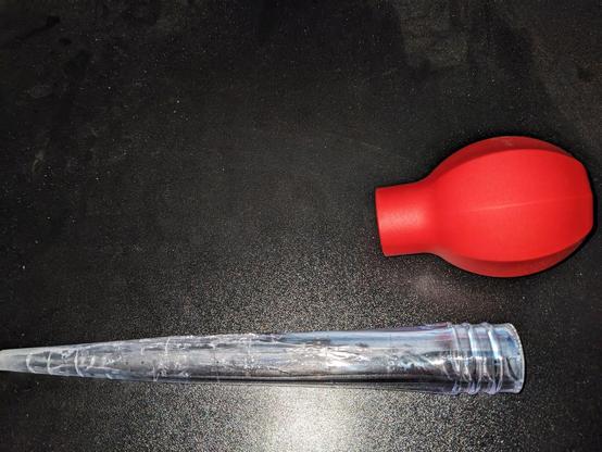 A turkey baster, cracked and destroyed after using it one time to suck power steering and brake fluid out of the car reservoirs.