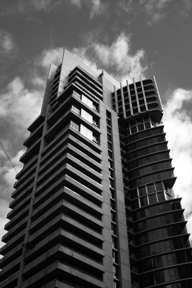 A skyscraper with sharp ribbing and points at its peak