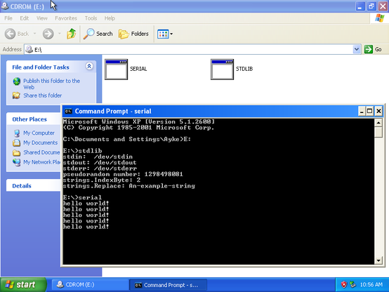 Screenshot of Windows XP (a VM), running two test TinyGo programs in a command prompt window. One is the testdata/stdlib.go program that imports a few standard library packages for very basic testing, the other (run afterwards) is a "hello world" style program that just continuously prints "hello world!" every second.

Both programs are loaded on an ISO (attached to the VM as a CDROM drive) because that's the only way I found to get files into the VM.