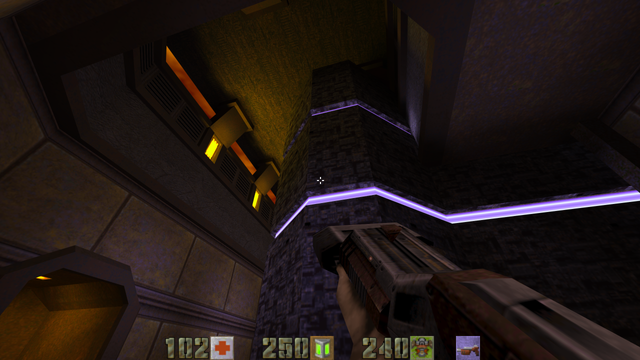 Bildschirmfoto aus Quake 2. In Ich-Perspektive ist ein Raum zu sehen, der eine Mischung aus High Tech mit farbig leuchten Leitungen und militärisch-düsteren Mauern und Decken ist.