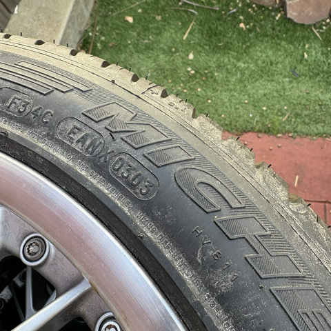 A close-up of the date stamp on the former spare tire removed from my engine donor 2003 BMW 530i, showing that the tire was manufactured in March 2003.