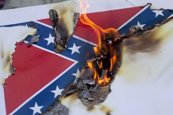A burning Confederate battle flag.