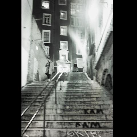 by night, 2 people in the stairs under light.Photo in black&white.
Lyon, France