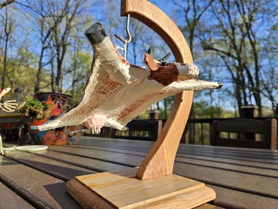 Figurine of a cream-and-sugar glider in mid-flight.